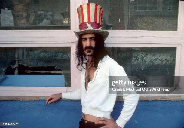 Rock and roll guitar player Frank Zappa poses for a portrait wearing an Uncle Sam stars & stripes top hat in March 1979 in Los Angeles, California.