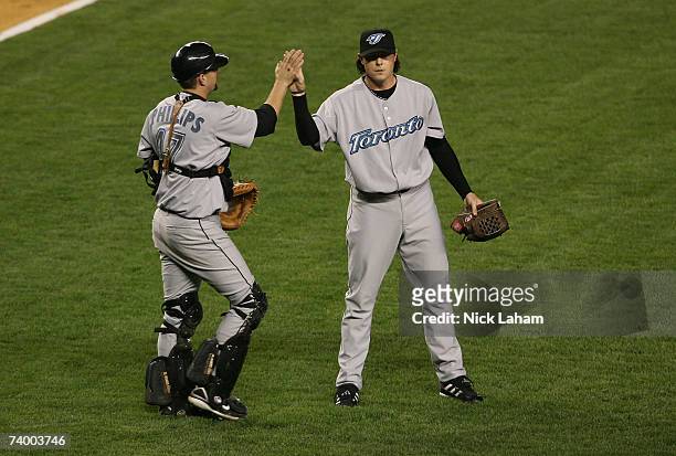 Jason Phillips of the Toronto Blue Jays celebrates a win with pitcher Scott Downs against the New York Yankees on April 26, 2007 at Yankee Stadium in...