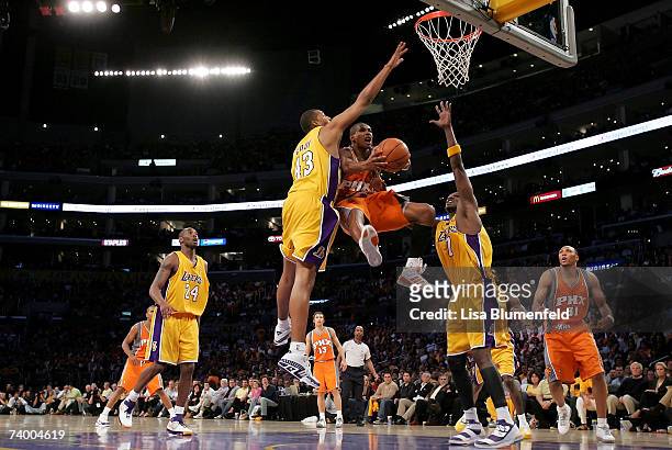 Leandro Barbosa of the Phoenix Suns goes to the basket against Brian Cook and Lamar Odom of the Los Angeles Lakers in Game Three of the Western...