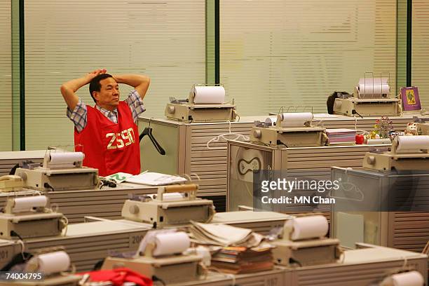 Hong Kong Stock Exchange trader watches during the ceremony to mark their Initial Public Offering at Hong Kong Stock Exchange on April 27, 2007 in...