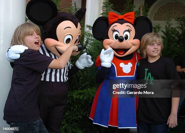 The Suite Life of Zack & Cody stars Dylan Sprouse and Cole Sprouse for the Disney Channel pose with Disney characters Mickey and Minnie before the...