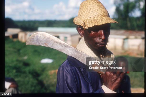 Man with a machete poses near the refugee camp May 5, 1994 in Rukumbell, Rwanda. Hundreds of Tutsis were killed at the Rukara Catholic mission April,...