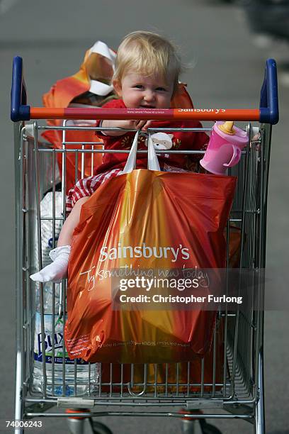 One-year-old Beatrice Halpin rides in a shopping trolley next to her mothers new Sainsbury's 'Bag for Life' on April 27, 2007 in Northwich, Cheshire....