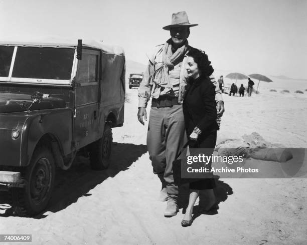 American actor John Wayne with his wife Pilar during a location shoot in Libya for the film 'Legend of the Lost', 1957.