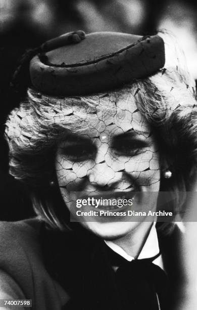 Princess Diana wearing a red pill box hat with a veil during a visit to Bristol, November 1983.