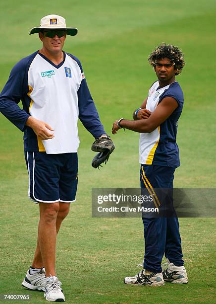 Lasith Malinga of Sri Lanka looks on with coach Tom Moody during a Sri Lanka team training session at the Kensington Oval on April 27, 2007 in...