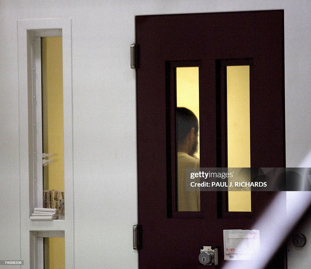 A detainee stands in his cell inside the...
