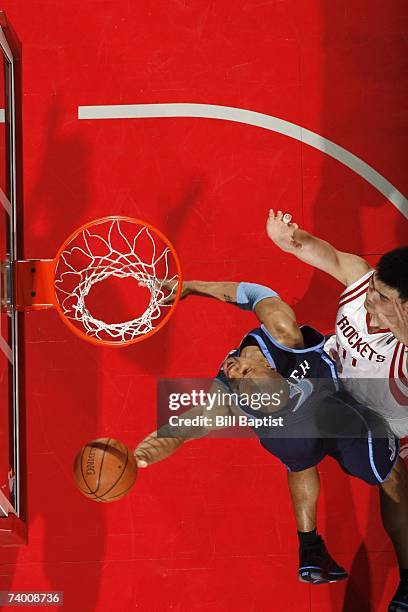Derek Fisher of the Utah Jazz shoots a layup against Yao Ming of the Houston Rockets in Game Two of the Western Conference Quarterfinals during the...