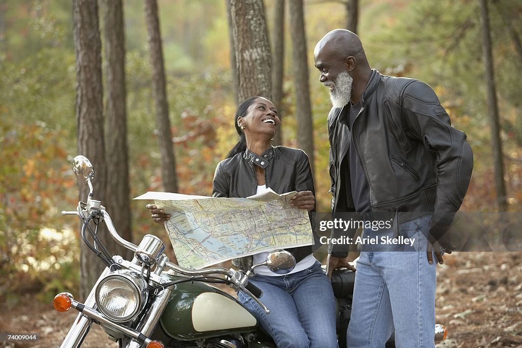 Senior African bikers looking at map