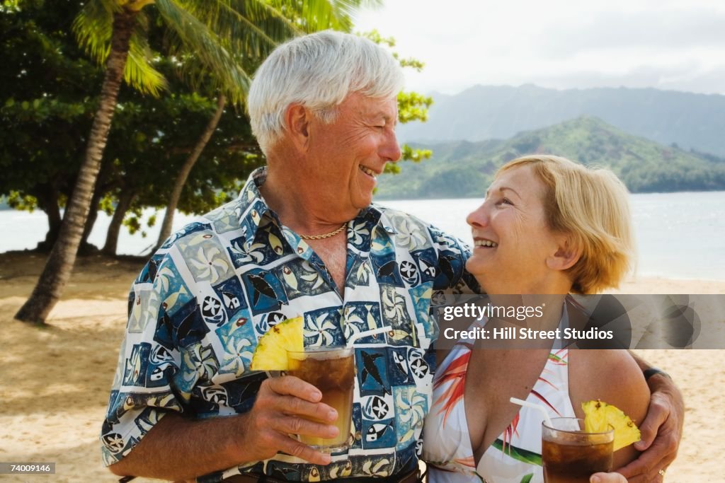 Senior couple smiling at each other in tropical scene