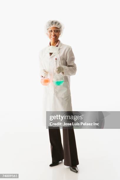 hispanic female scientist holding beakers - science white background ストックフォトと画像