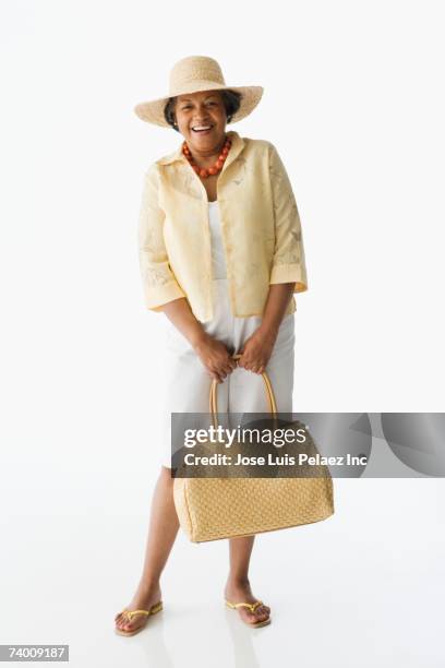 senior african woman holding purse - tote bag stock pictures, royalty-free photos & images