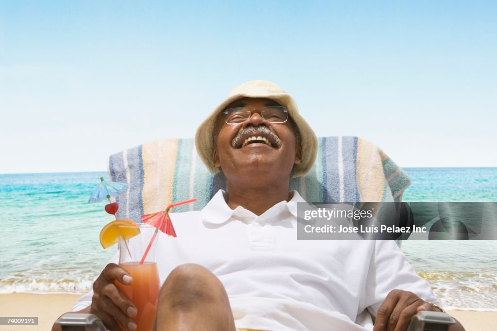 Senior African man relaxing in beach chair