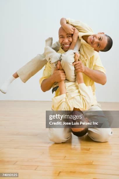 indian father and sons playing - mixed wrestling imagens e fotografias de stock