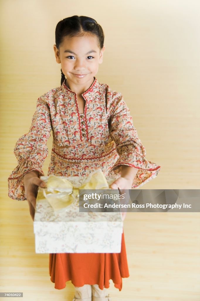 Portrait of Pacific Islander girl holding gift