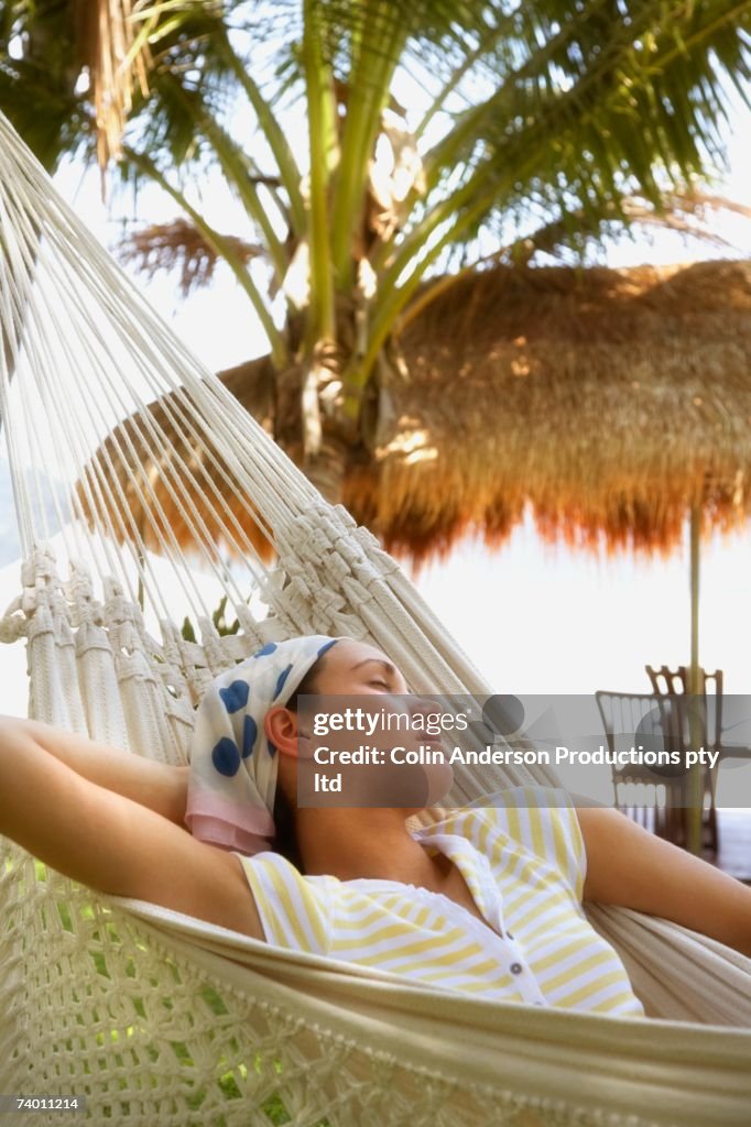 Pacific Islander woman sleeping in hammock