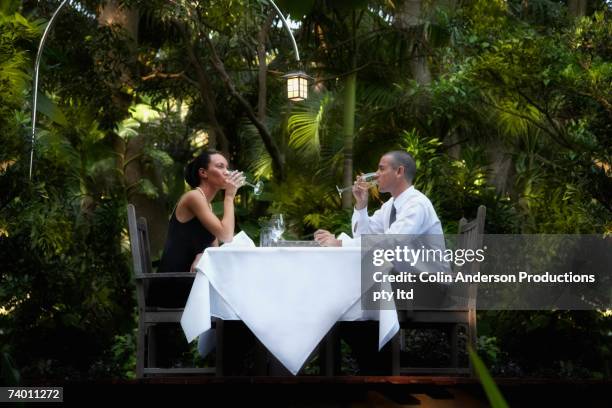couple eating at outdoor restaurant - formal dining stock pictures, royalty-free photos & images