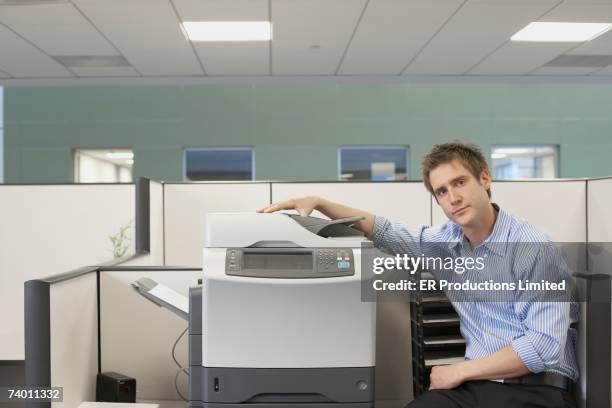 businessman sitting next to copy machine - erbore stock pictures, royalty-free photos & images