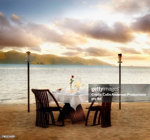 table set for two at beach - romantic picnic stockfoto's en -beelden