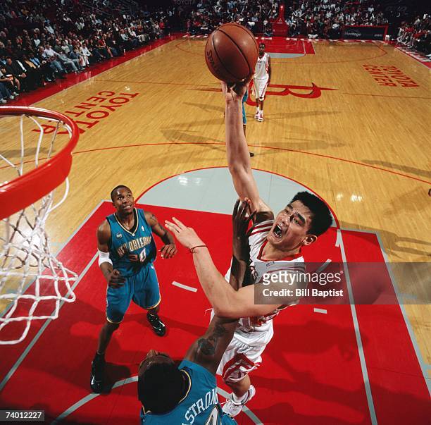 Yao Ming of the Houston Rockets shoots over Hilton Armstrong of the New Orleans/Oklahoma City Hornets during a game at Toyota Center on April 14,...