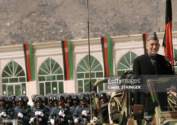 Afghan president Hamid Karzai drives by during a Mojahidin victory celebration in Kabul, 28 April 2007. Afghanistan displayed its growing military...