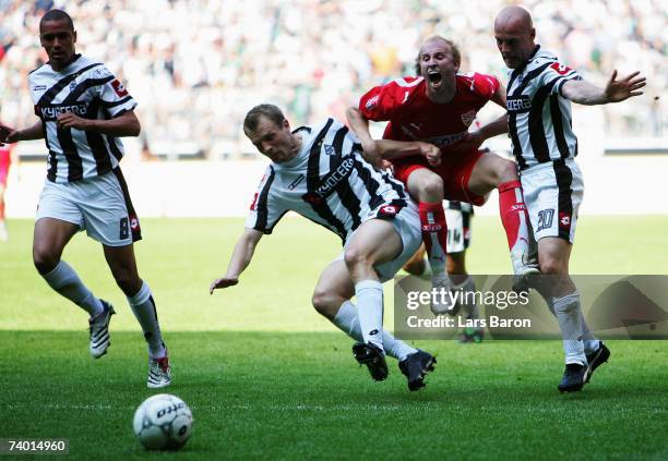 Bo Svensson and Kaspar Bogelund of Monchengladbach in action with Ludovic Magnin of Stuttgart during the Bundesliga match between Borussia...