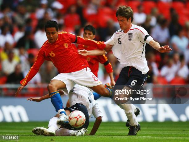 Thiago Alcantara Do Nascimento of Spain is tackled by Ben Gordon and Thomas Cruise of England during the International Friendly match between England...