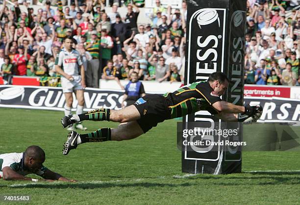 Mark Robinson of Northampton dives over to score his team's third try during the Guinness Premiership match between Northampton Saints and London...