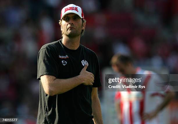 Coach Juergen Klopp of Mainz puts his hand on his heart as he looks at the Mainz fans after losing 1:2 the Bundesliga match between FSV Mainz 05 and...