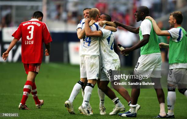 Lucio of Bayern Munich leaves the pitch while players of Hamburger SV celebrate after the Bundesliga match between Bayern Munich and Hamburger SV at...