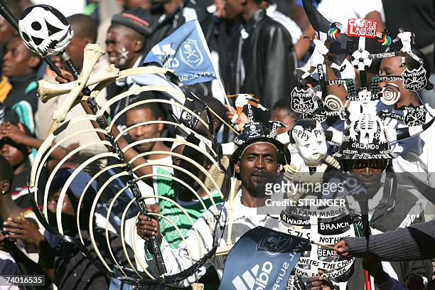 Johannesburg, SOUTH AFRICA: TO GO WITH AFP STORY Orlando pirates supporters cheer, 28 April 2007, during the football match between Orlando Pirates...
