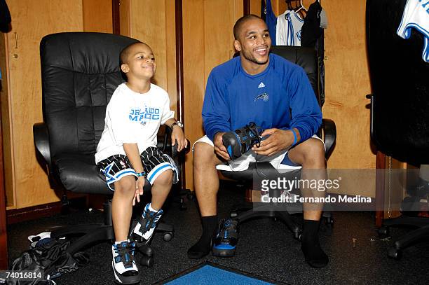 Jameer Nelson of the Orlando Magic sits in the locker room with his son before playing against the Detroit Pistons in Game Four of the Eastern...