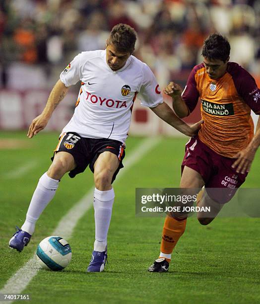 Valencia?s Joaquin Sanchez fights for the ball with Recreativo Huelva?s Cesar Arzo during their Spanish league football match at Mestalla Stadium in...