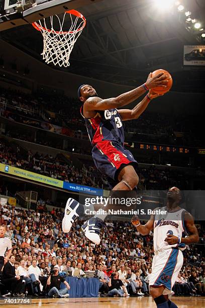 LeBron James of the Cleveland Cavaliers dunks against DeShawn Stevenson of the Washington Wizards in Game Three of the Eastern Conference...