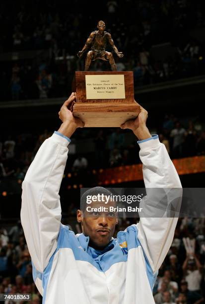 Marcus Camby of the Denver Nuggets accepts the NBA Defensive Player of the Year Award before taking on the San Antonio Spurs in Game Three of the...