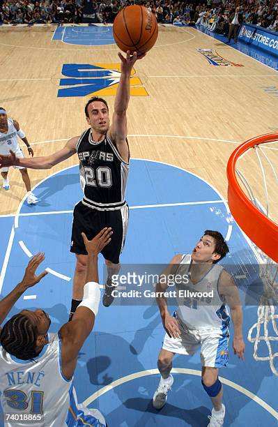 Manu Ginobili of the San Antonio Spurs goes to the basket against Nene of the Denver Nuggets in Game Three of the Western Conference Quarterfinals...