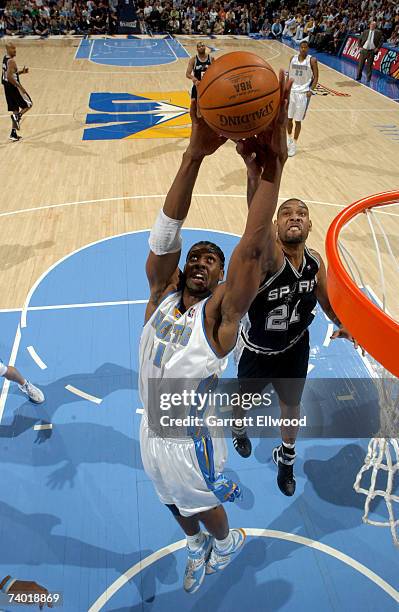 Nene of the Denver Nuggets goes to the basket against Tim Duncan the San Antonio Spurs in Game Three of the Western Conference Quarterfinals during...