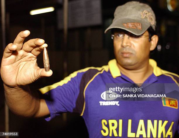 Sri Lankan cricket fan shows a bullet that fell after security forces fired a barrage of tracer bullets and heavy calibre anti-aircraft weapons after...