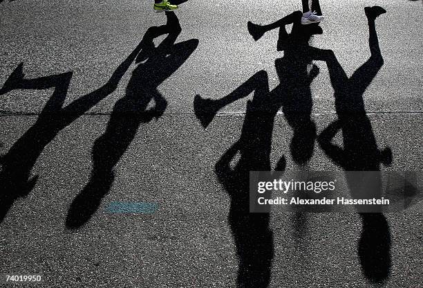 Runners cast shadows during the Hamburg Conergy Marathon on April 29, 2007 in Hamburg, Germany.