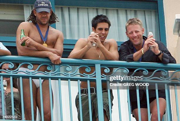 Australian cricketer Andrew Symonds and his teammate Mitchell Johnson look at their captain Ricky Ponting from their hotel balcony in Bridgetown, 29...