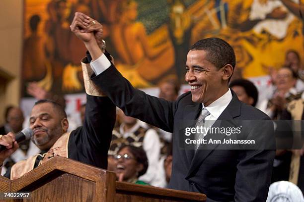 Senior Minister John J. Hunter raises the hand of Democratic presidential hopeful Senator Barack Obama during a service commemorating the Los Angeles...