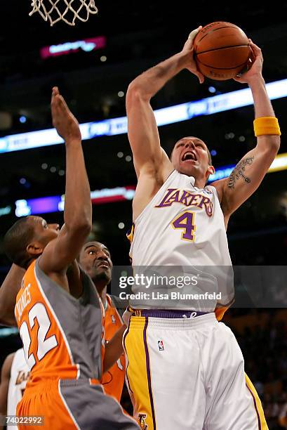 Luke Walton of the Los Angeles Lakers goes to the basket over James Jones and Amare Stoudemire of the Phoenix Suns in Game Four of the Western...