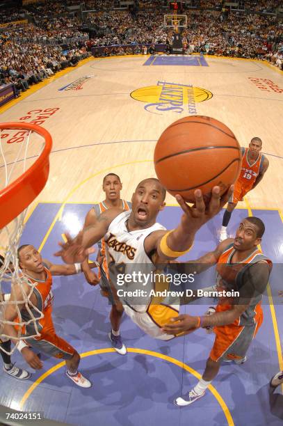 Kobe Bryant of the Los Angeles Lakers goes strong to the hoop against Amare Stoudemire, Shawn Marion and Boris Diaw of the Phoenix Suns in Game Four...