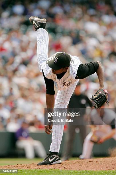 Reliever Denny Bautista of the Colorado Rockies throws a passed ball to Kelly Johnson of the Atlanta Braves who advanced to first base in the 11th...