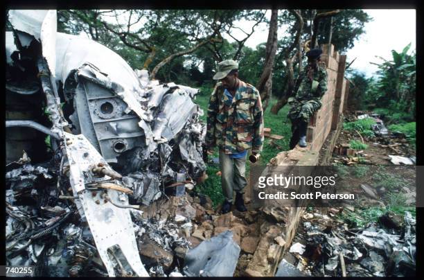 Armed Rwanda Patriotic Front soldiers investigate the site of the plane crash that killed President JuvTnal Habyarimana May 26, 1994 in Kigali,...