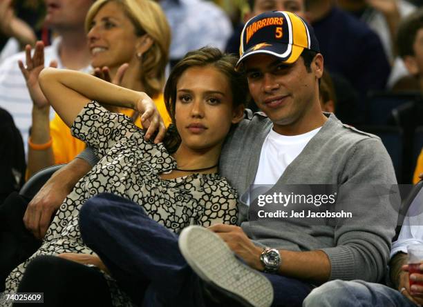 Actor Jessica Alba looks on with Cash Warren during the Dallas Mavericks and the Golden State Warriors Game Four of the Western Conference...
