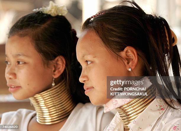 By Shino Yuasa Karen long-necked teenagers, Muko and Amy sit at souvenir stall in Huay Pu Keng village near the Thai-Myanmer border, 06 April 2007. A...