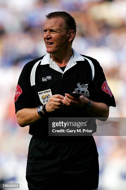 Referee Graham Poll makes a note in his book during the Barclays Premiership match between Wigan Athletic and West Ham United at The JJB Stadium on...