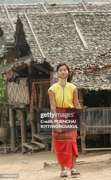 By Shino Yuasa A Karen long-necked woman walks past shelters in Huay Pu Keng village near the Thai-Myanmer border, 06 April 2007. A growing number of...