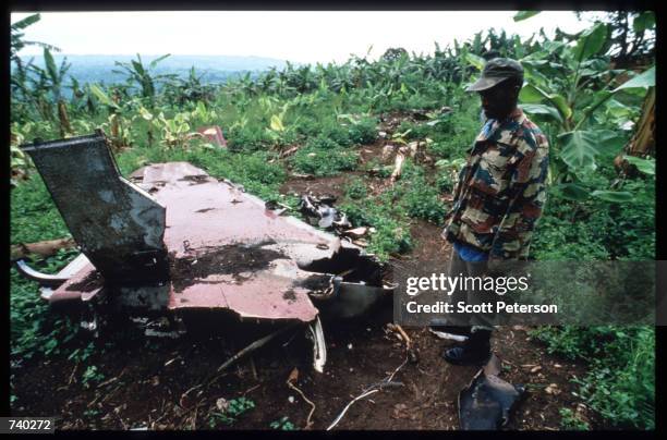 Rwandan Patriotic Front soldier investigates the site of the plane crash May 26, 1994 that killed President JuvTnal Habyarimana in Kigali, Rwanda....